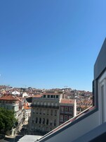 A cityscape with historic buildings and a clear blue sky.