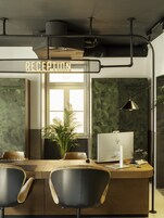 A reception desk with a computer, a plant, and a sign that reads "RECEPTION".