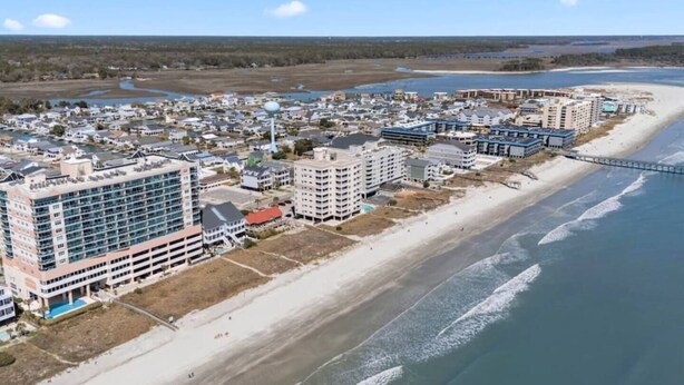 A coastal town with beachfront hotels, a bridge, and a clear view of the ocean. - Corner, Oceanfront Balcony- Pool- Upscale Design (North Myrtle Beach)