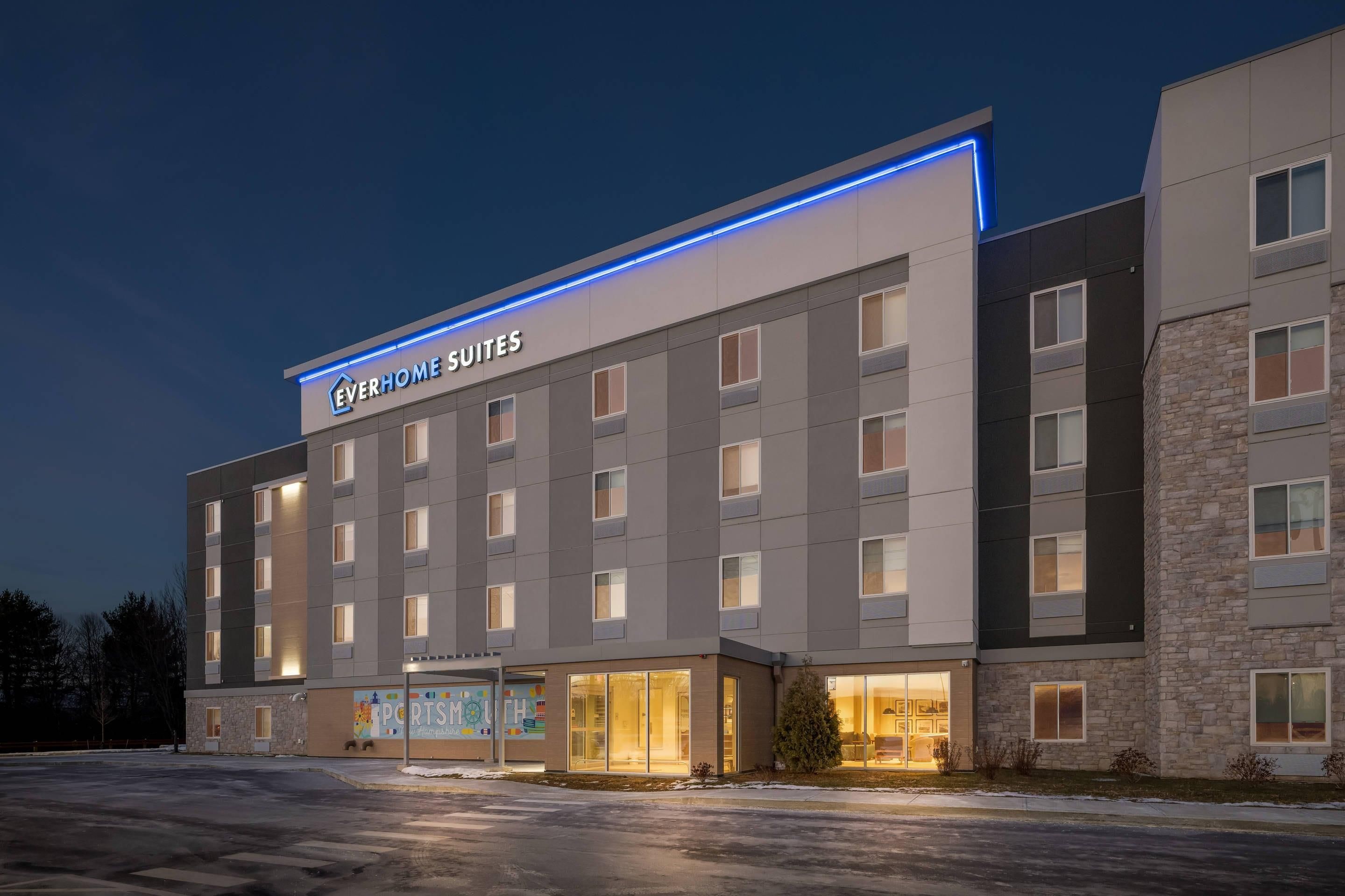 A hotel with multiple floors, a sign for 'Everhome Suites', and a storefront with 'Sportsmouth' visible.