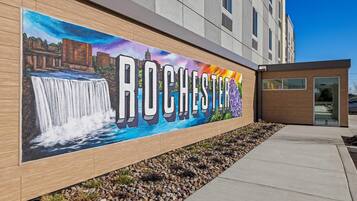 A mural with the word "ROCHESTER" and a waterfall scene on a building facade.