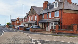 A row of red brick houses with a street in front. - 2 bedroom accommodation in Whitby (Whitby)
