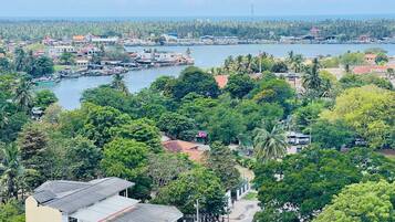 A coastal town with a marina, dense greenery, and residential buildings.
