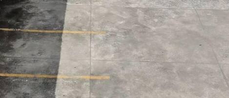 A parking area with marked spaces and a concrete surface.