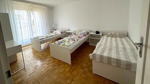 A room with two single beds, a desk, and a chair. - Apartment Near Schonbrunn Palace Vienna (Vienna)