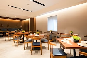 A modern dining area with multiple tables and chairs, a large window, and a minimalist design. - Yitel Collection (Shanghai)