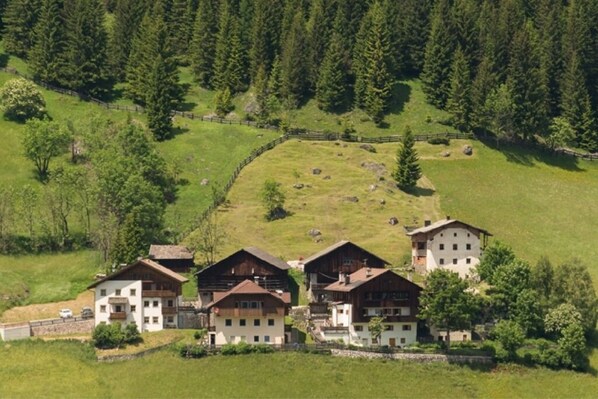 A cluster of chalet-style buildings with a mountainous backdrop.