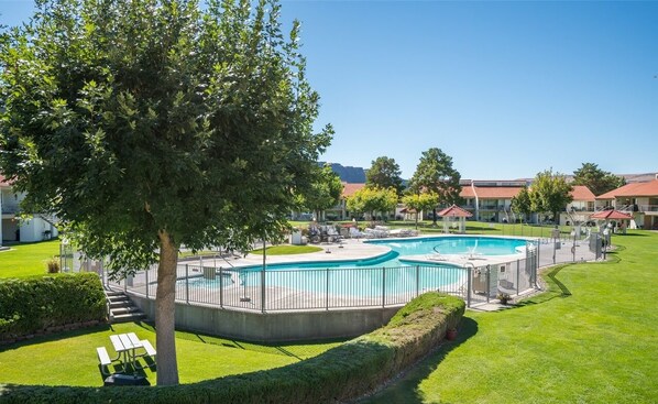 Relax by the pool surrounded by lush greenery and beautifully trimmed hedges.