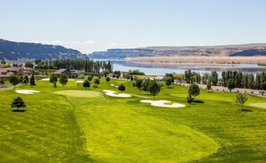Enjoy a serene golf course experience with breathtaking views of the surrounding landscape and water.