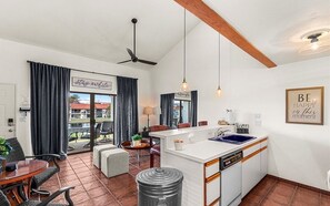 Enjoy cooking and dining in this well-equipped kitchen with a central island, sink, and dishwasher, complemented by a dining area and cozy seating.