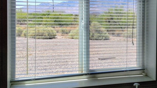 A bathroom with a window overlooking a desert landscape. - Gila Valley Escape (Central)
