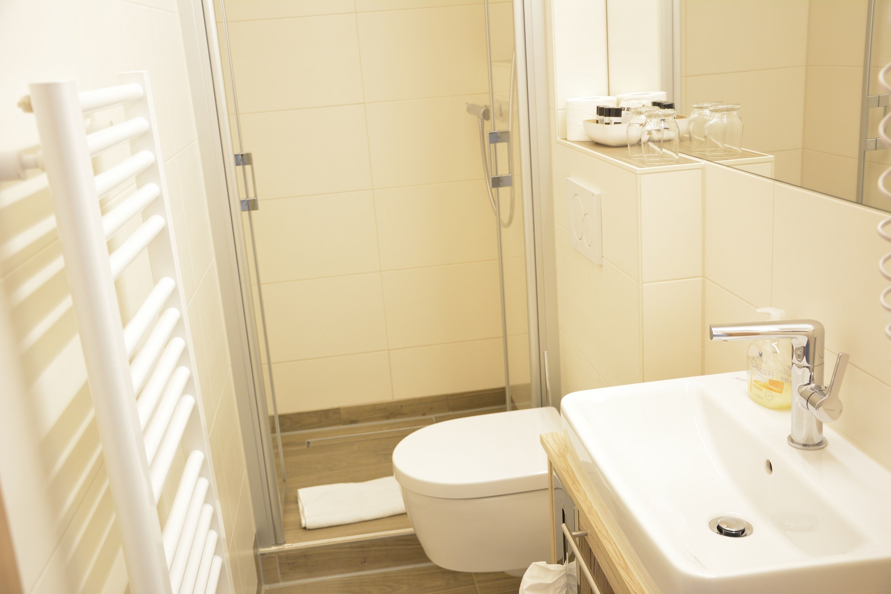 A bathroom with a toilet, sink, and shower.