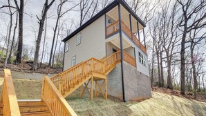 A two-story house with a wooden staircase leading to a balcony. - 6 Mi to Chattanooga: Home w/ Balcony & Dtwn Views! (Rossville)
