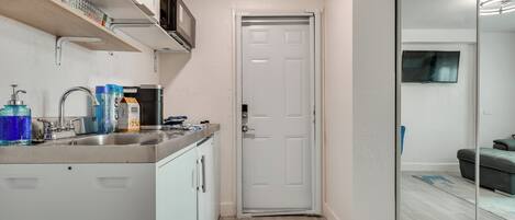 Fridge, microwave, coffee/tea maker, cookware/dishes/utensils