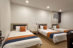 A hotel room with three beds, each with a white and orange bedspread, a wooden headboard, and a nightstand. - Shanghai Jinxiang Hotel (Zhujiajiao Ancient Town) (Shanghai)