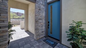 A stone exterior with a blue door, a doormat, and a potted plant. - Resort-Style Gated, Pool Gym Near Downtown Phoenix & Chase Field Hiking Mountain (Phoenix)