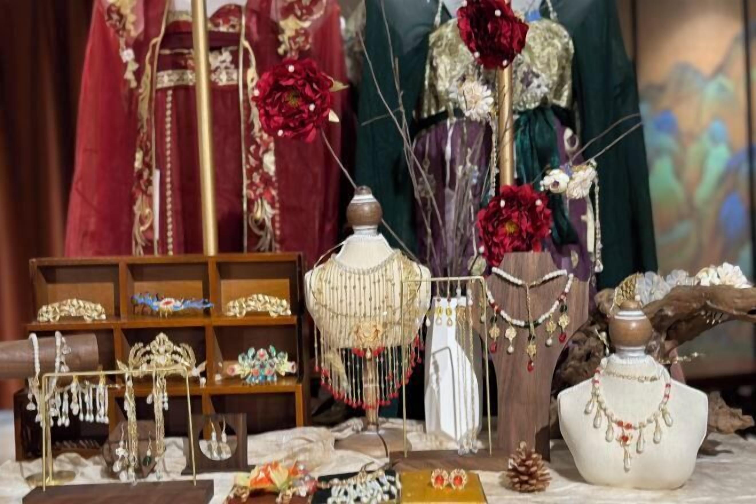 A display of jewelry with various pieces on mannequins and shelves, including necklaces, earrings, and bracelets.