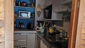 A compact kitchen with a microwave, sink, and various utensils. - New for rent, spacious 65m² duplex facing south.  (Val d'Isère)