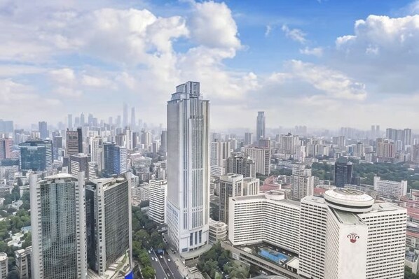 A cityscape with high-rise buildings, including a prominent skyscraper.