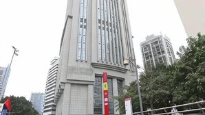 A tall building with a modern design, featuring a vertical emphasis and a series of windows. - Hemu International Apartment (Guangzhou)
