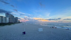 A beach with a row of high-rise buildings in the background. - Forget your worries in this spacious and serene space. (Gulf Shores)
