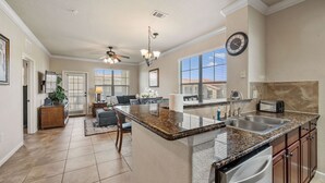 A spacious kitchen with granite countertops, stainless steel appliances, and a large island. - Close To Disney, Clubhouse With Gym, Communal Pool (Davenport)