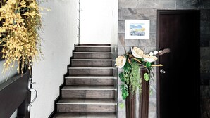 A staircase with a dark wooden finish, leading to a room with a dark wooden door and a framed picture on the wall. - Stylish family boutique house, 10 minutes from downtown Oaxaca. (Oaxaca City)