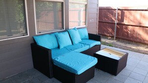 A patio area with a sectional sofa and a coffee table. - Work Play Stay Pet-friendly With Foosball (Aubrey)
