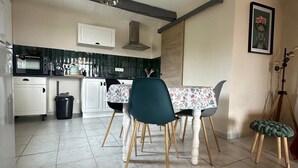 A modern kitchen with a dining area.