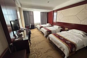 A hotel room with two beds, a desk with a computer, a TV, and a large window with curtains. - Guo Tai Yue Gang Hotel (Zhaosu)