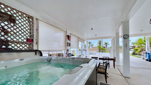A hot tub area with a view of the street and palm trees.