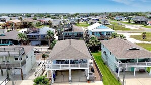A coastal residential area with houses featuring balconies and waterfront views.