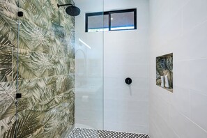 A shower with a glass door, a small window, and a patterned tile wall. - Boutique Nature Villa Near Potrero Beach • Pool • Fast WiFi • Self Check-In (Provincia de Guanacaste)