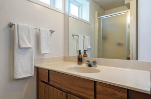 Shower, towels, soap, toilet paper - Vibrant basement suite, blending style and comfort for a delightful stay. (Drumheller)