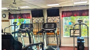 A fitness center with treadmills, a stationary bike, and a rowing machine. -  hotel suite with WiFi, fitness room in brilliant Orlando (Orlando)