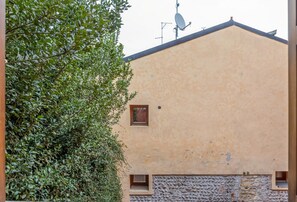 A building with a beige exterior, satellite dish, and a small window.