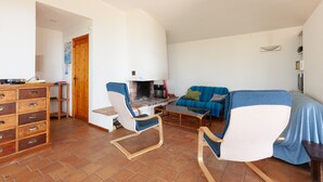 A living room with a sofa, chairs, a coffee table, a fireplace, and a wooden cabinet. - Holiday Home 'Catherine Vue Mer Et Terrasse' with Sea View, Private Terrace and Wi-Fi (Carqueiranne)