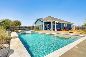 A rectangular swimming pool with clear blue water, surrounded by a concrete deck. - Private Pool & Hot Tub: 'Wild Horse' Home! (College Station)
