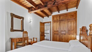 A bedroom with a wooden bed, a wooden desk with a chair, a large mirror, and a wardrobe. - Apartment 'Cantu' with Private Terrace, Balcony and Wi-Fi (Bustio)