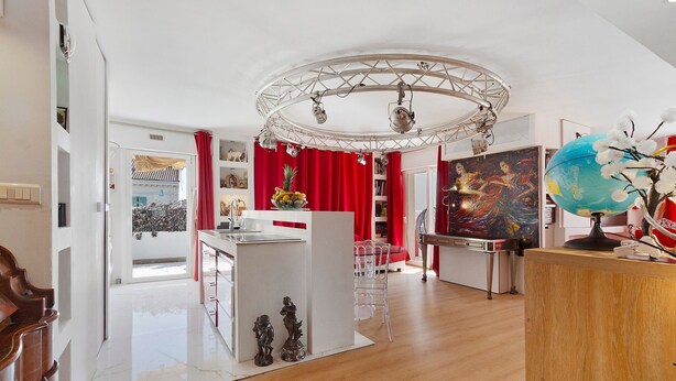 A modern interior with a dining area, a globe, and a painting. - Apartment 'Le Loft' with Mountain View, Wi-Fi and Air Conditioning (Cannes)