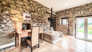 A stone-walled room with a desk, chair, and a fireplace. - Cottage 'Leyetaz' with Lake View, Private Terrace and Wi-Fi (Châtillon-sur-Cluses)