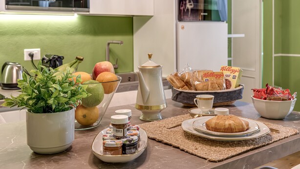 A kitchen counter with breakfast items, a coffee maker, and a microwave.