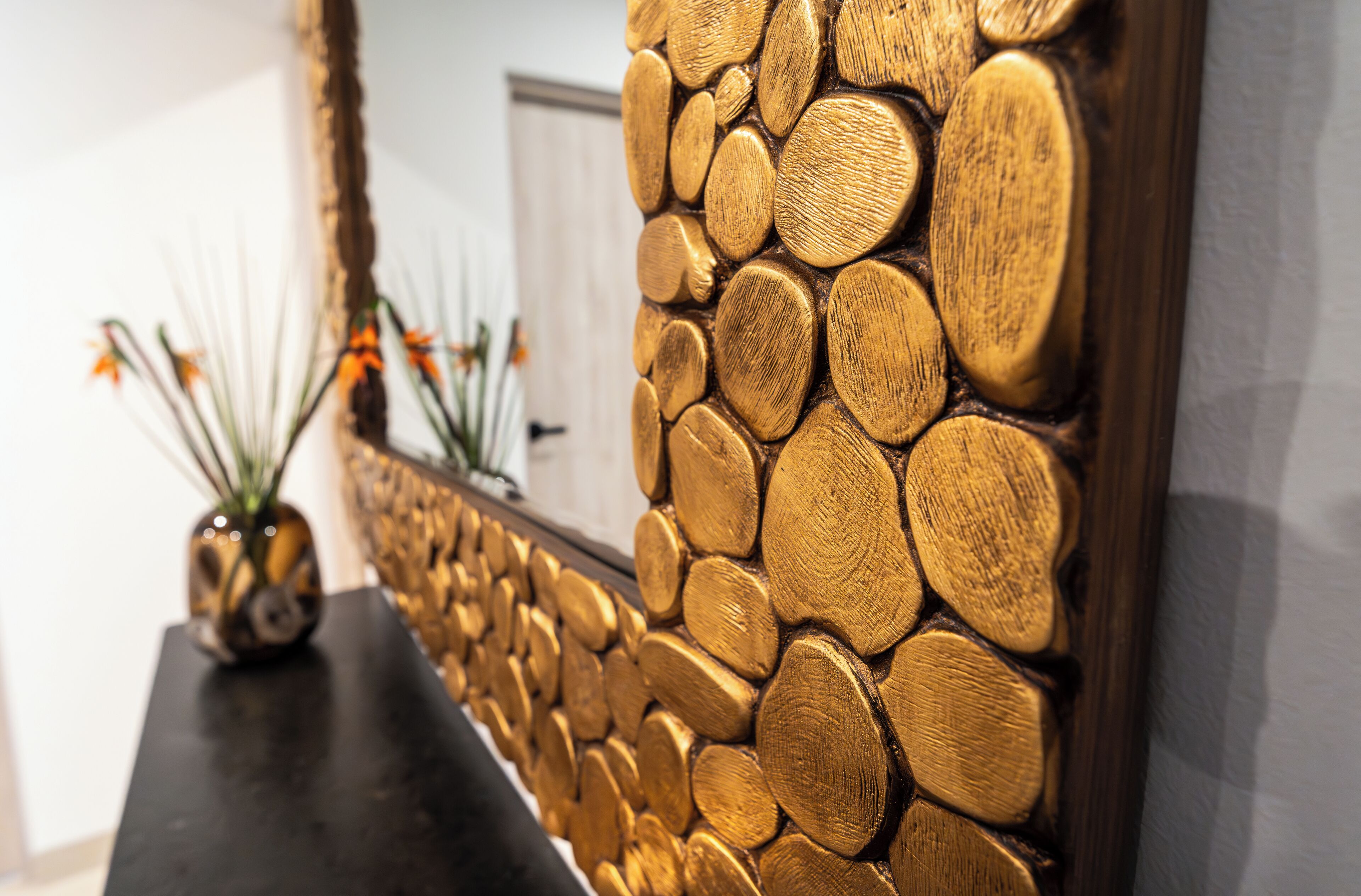 A wall with a textured, wooden log design.