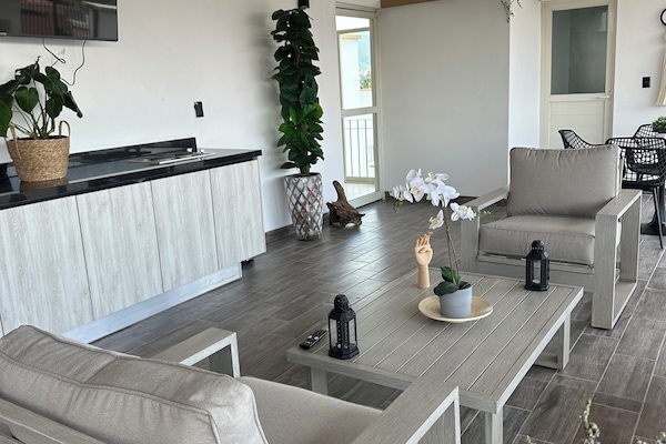 Family Apartment, Balcony, City View | Living area | 65-inch LED TV with digital channels