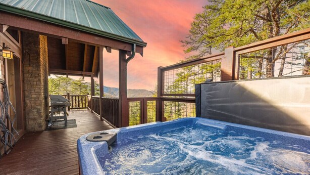 A hot tub on a wooden deck with a view of trees and hills. - Big Blue Ridge | MTN Views, Hot Tub, Pool Table! (Sevierville)