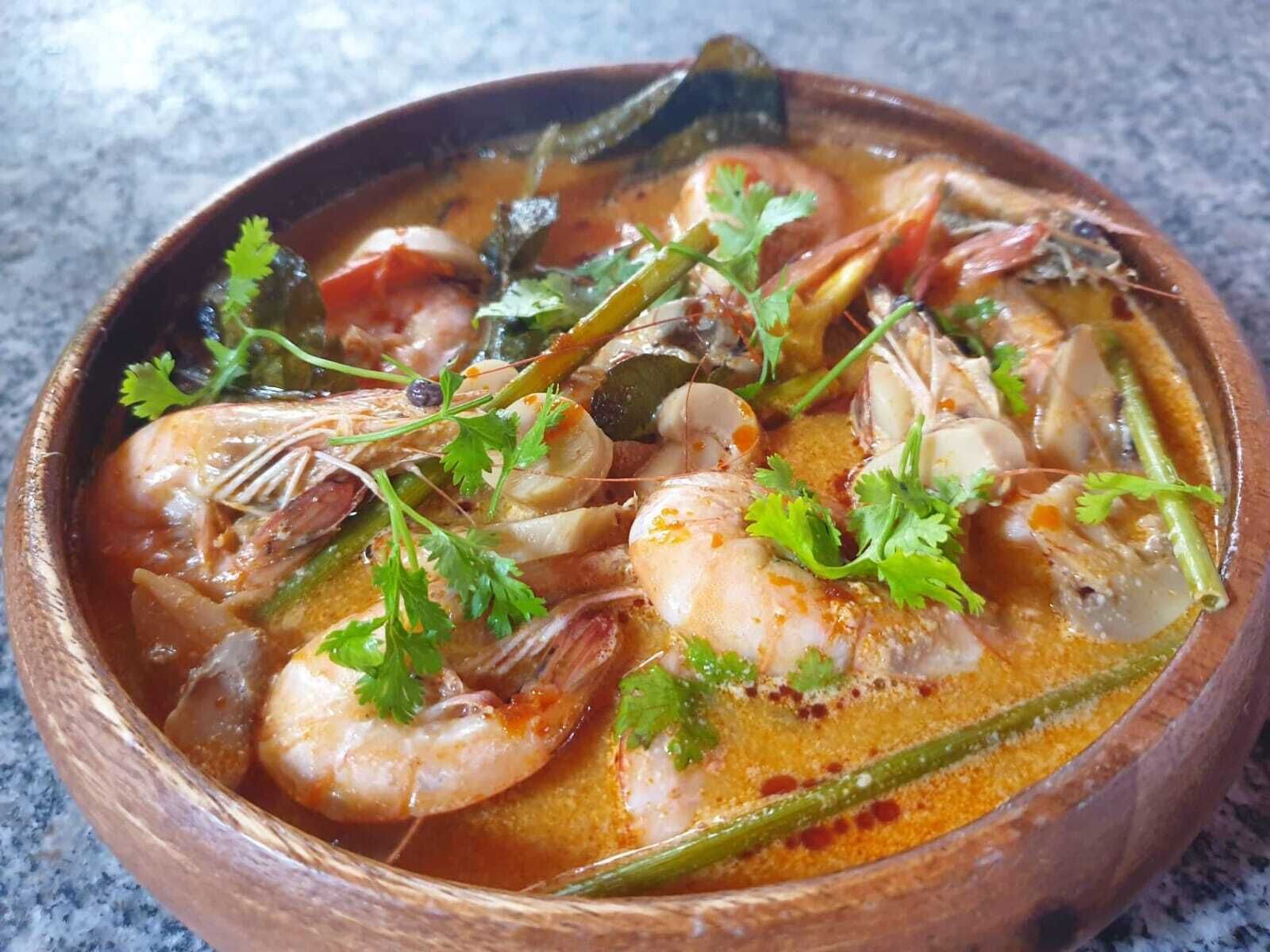 A bowl of seafood soup garnished with cilantro.
