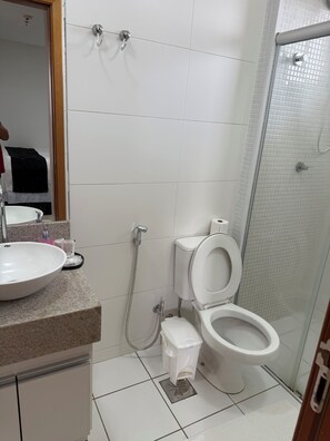 A bathroom with a sink, toilet, and shower.
