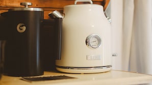 A kitchen with a coffee maker and a grinder on a wooden table. - Cozy Rustic Sailors Room (Houston)