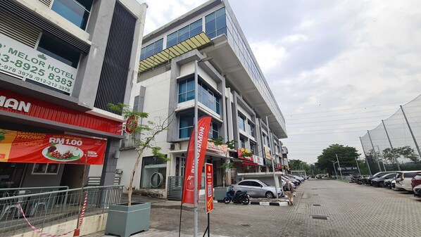 A multi-story building with a modern architectural design, featuring large windows and a flat roof.