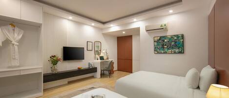 A hotel room with two beds, a TV, a desk, a mirror, and a painting on the wall.